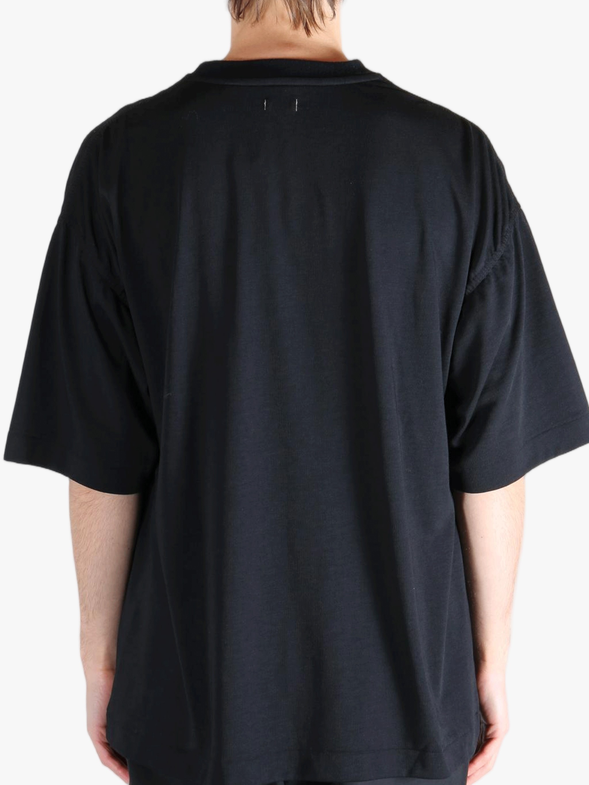 Black t-shirt worn by a person, showing the t-shirt's fit
