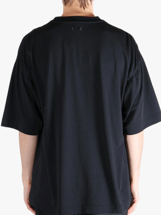 Black t-shirt worn by a person, showing the t-shirt's fit