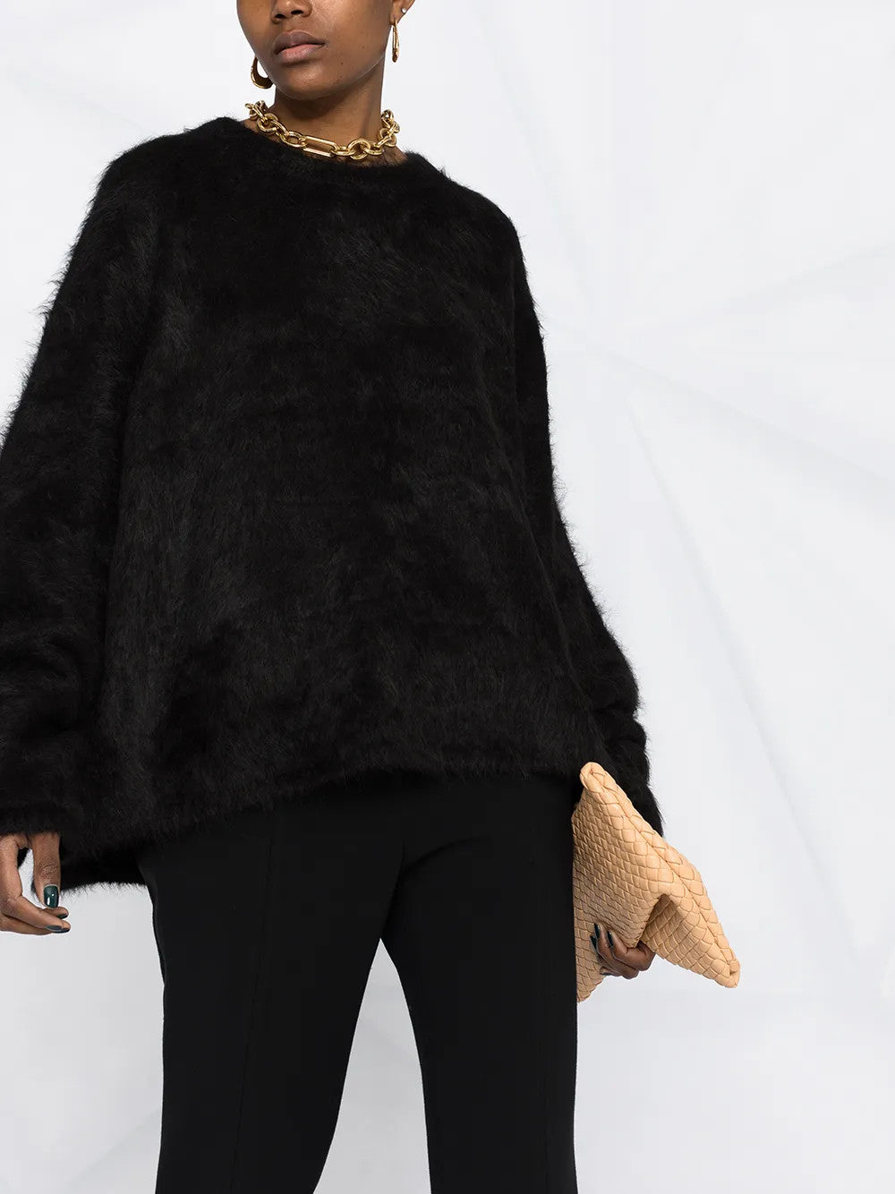 Black knitwear worn by a person, showing the knitwear fit