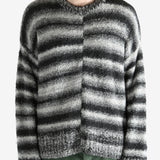 Black knitwear worn by a person, showing the knitwear's fit