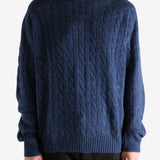 Navy sweater worn by a person, showing the sweater's fit