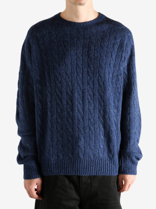 Navy sweater worn by a person, showing the sweater's fit