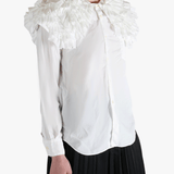 White shirt worn by a person, showing the shirt's fit