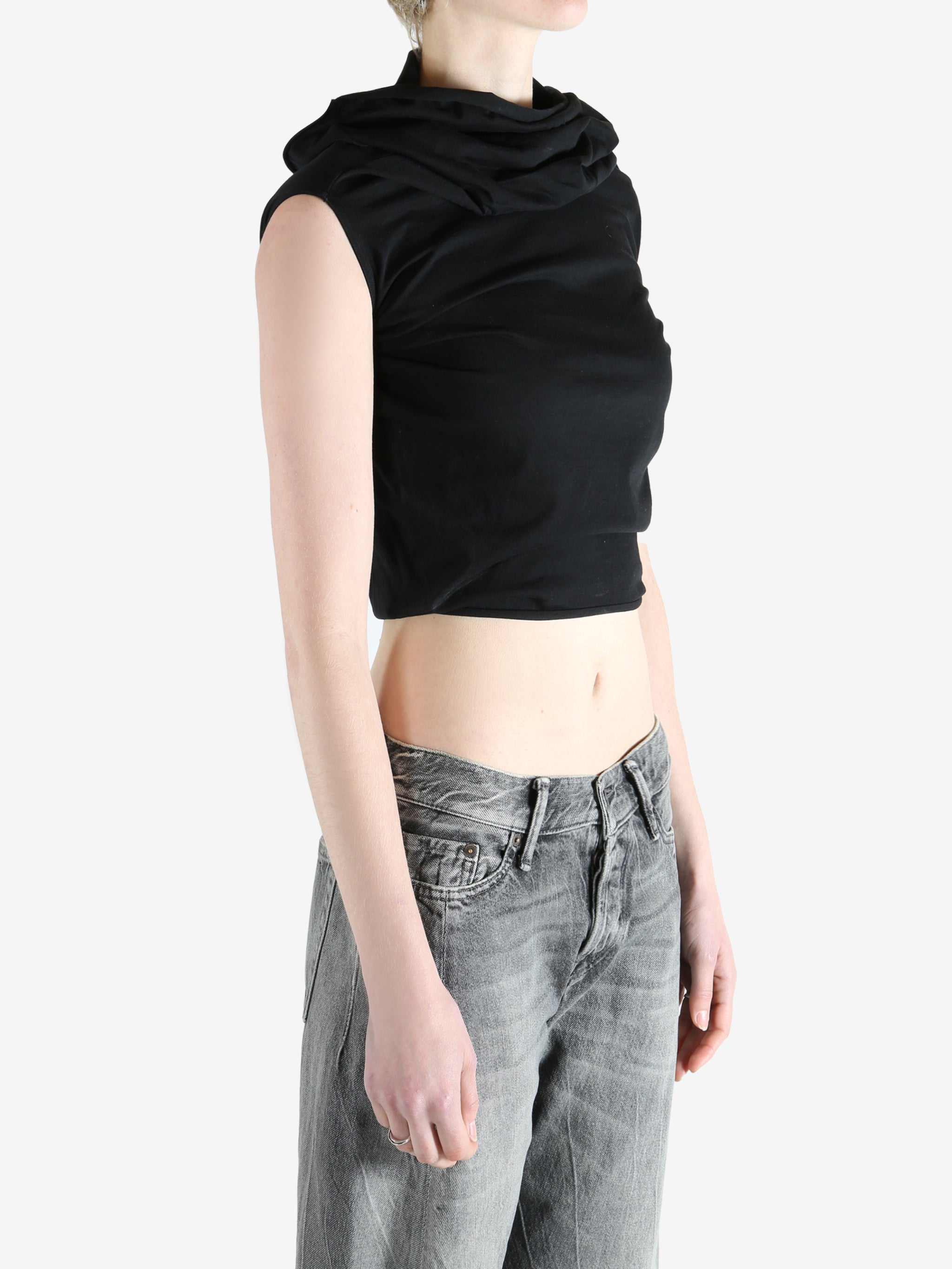 black sleeveless top worn by a person, showing the top fit