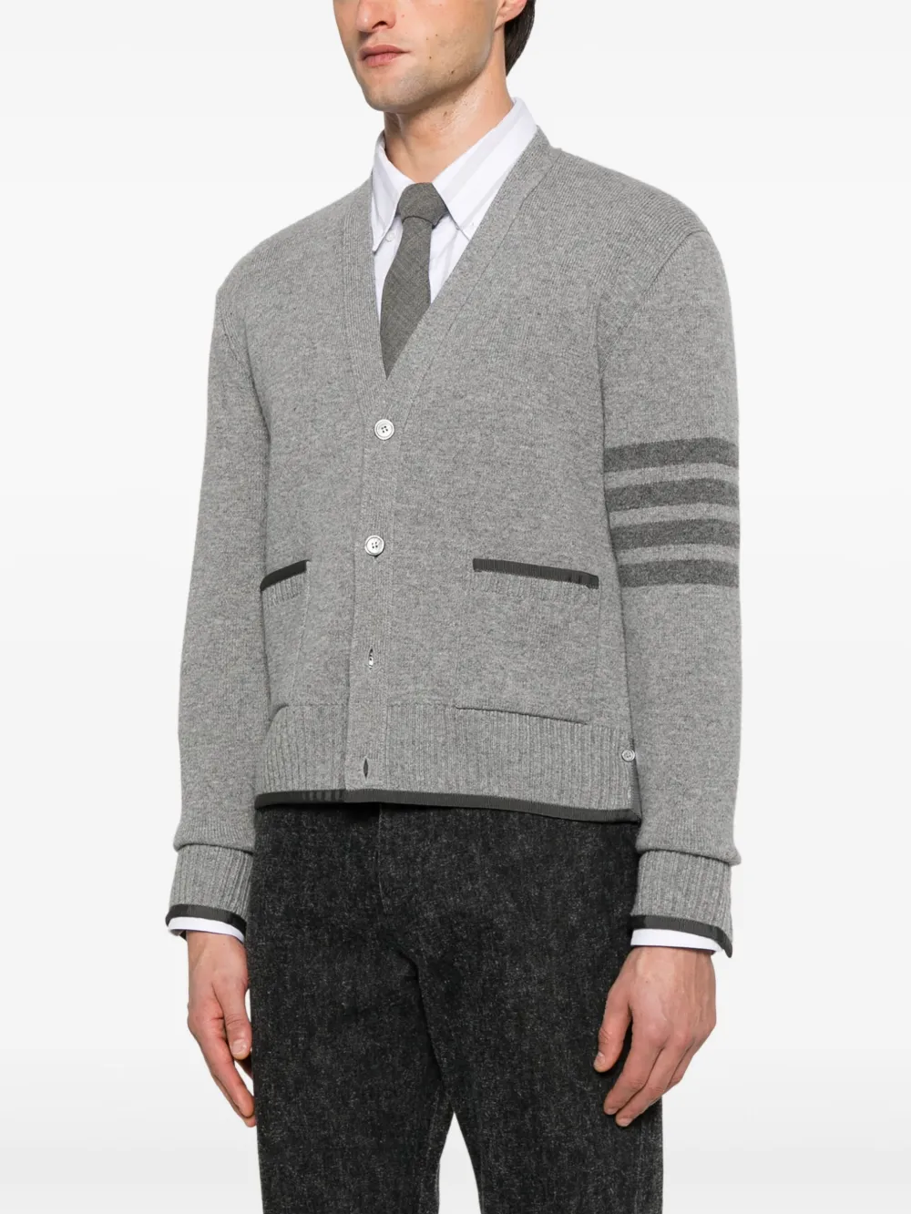 Grey knitwear worn by a person, showing the knitwear's fit