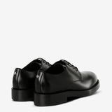 Black derby, back view