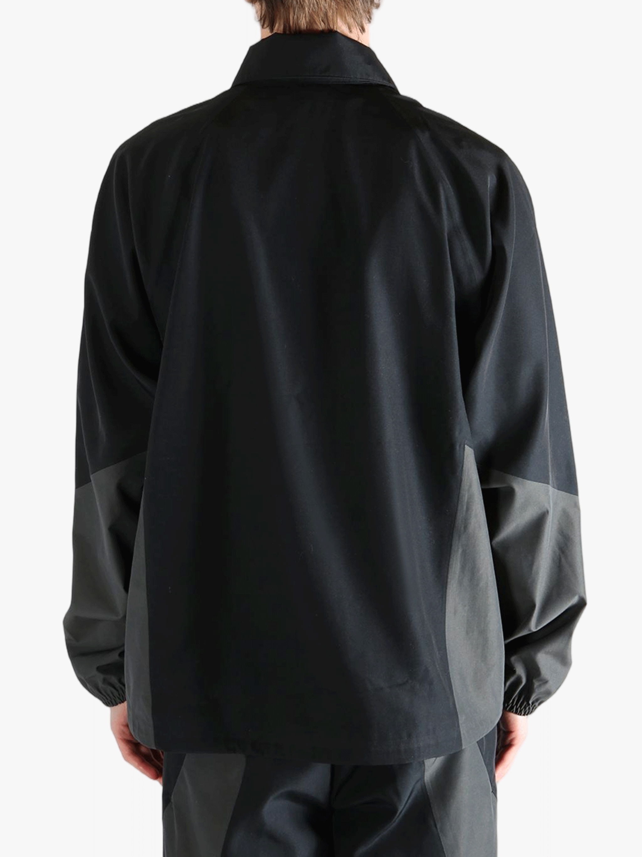 Black jacket worn by a person, showing the jacket's fit