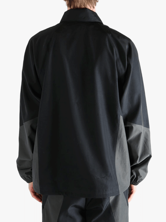 Black jacket worn by a person, showing the jacket's fit