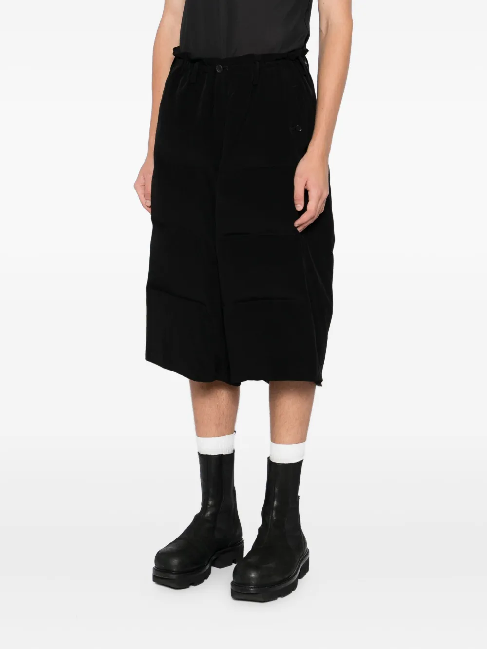 Black pants worn by a person, showing the pants fit