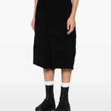 Black pants worn by a person, showing the pants fit