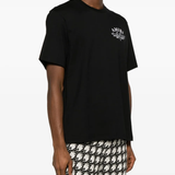 Black t-shirt, worn by a person, showing the shirt's fit