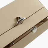 Close up of beige bag, showing the detial of the buckle