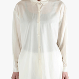 White shirt worn by a person, showing the shirt's fit
