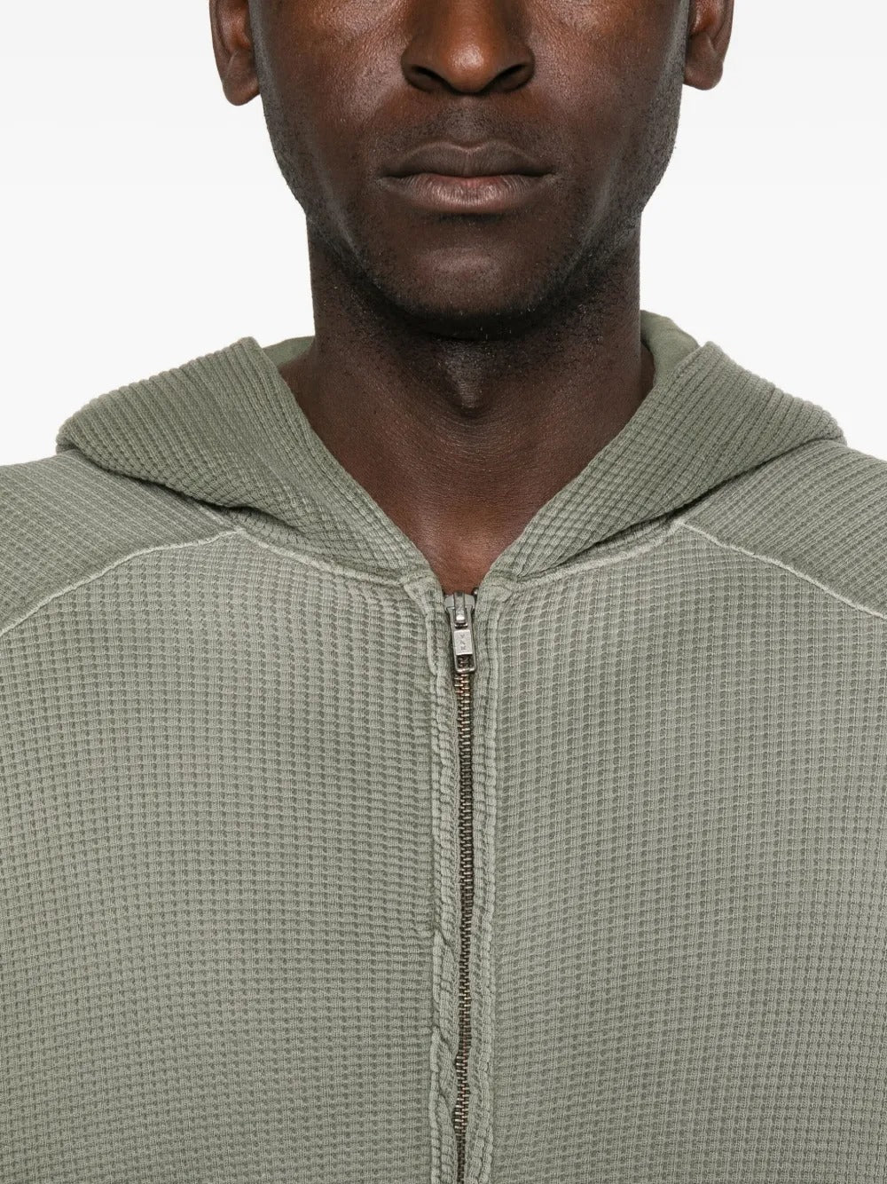 Close up of the green hoodie, showing texture of the cotton fabric