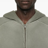 Close up of the green hoodie, showing texture of the cotton fabric