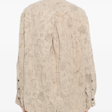 Tan shirt worn by a person, showing the shirt's fit