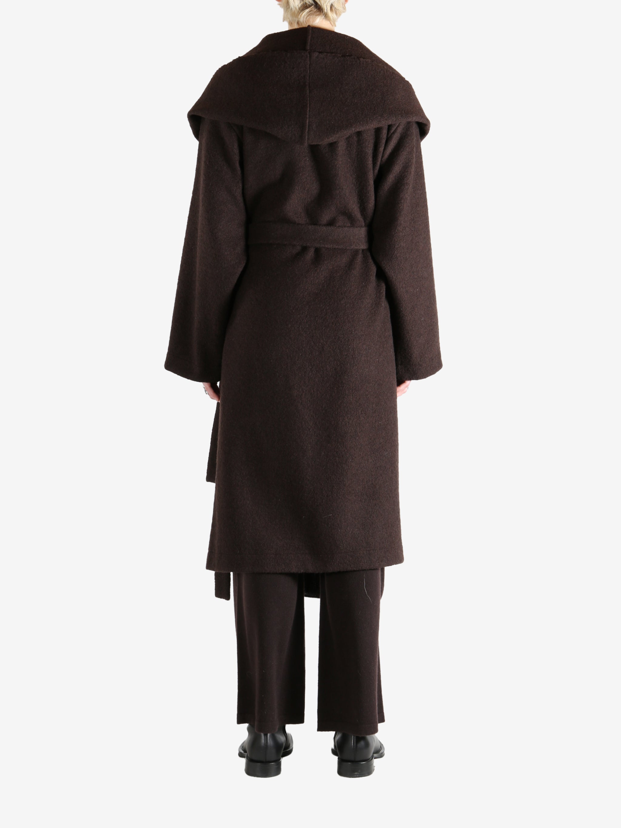 Brown coat worn by a person, showing the coat fit