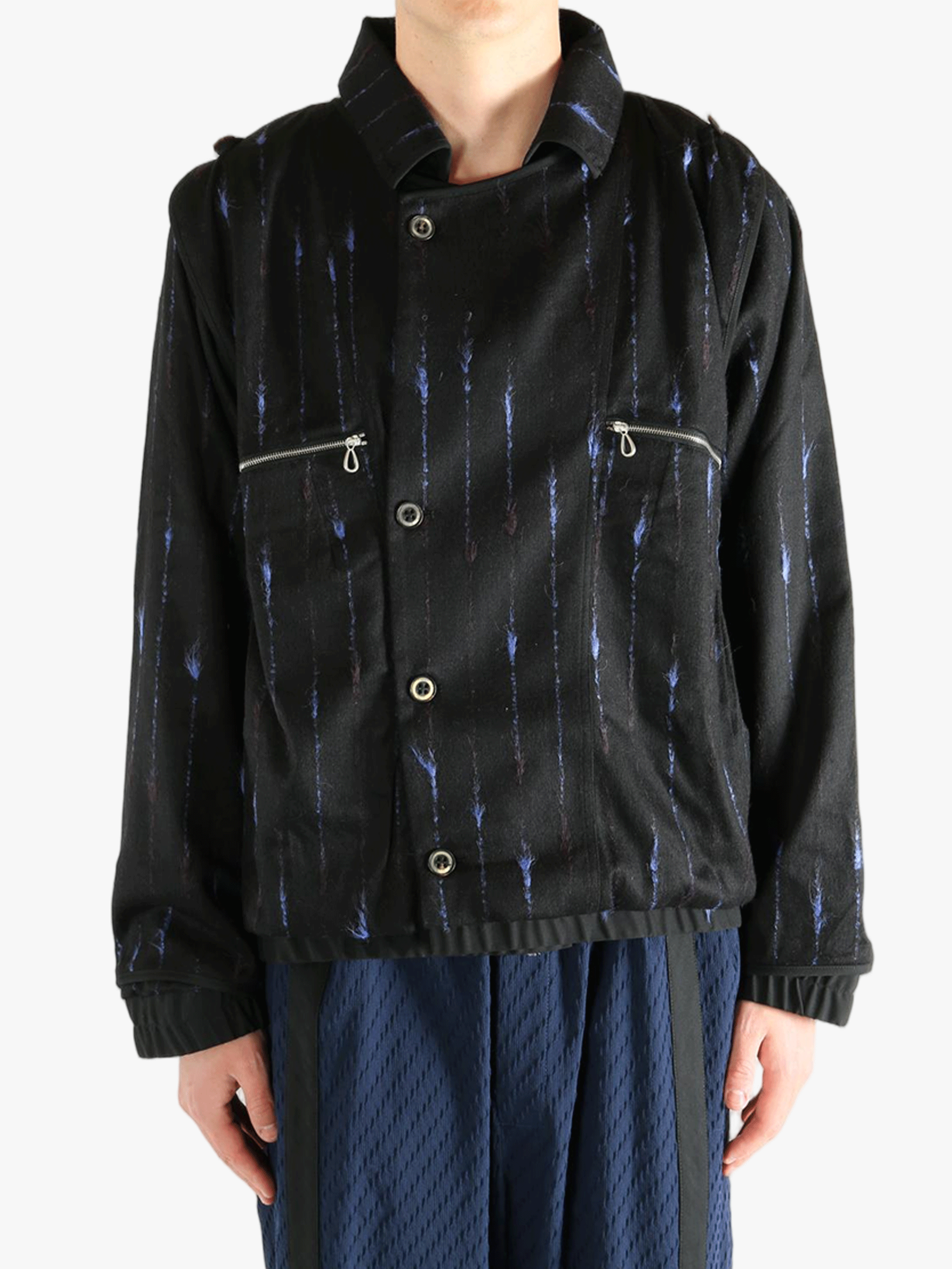 Black jacket worn by a person, showing the jacket's fit