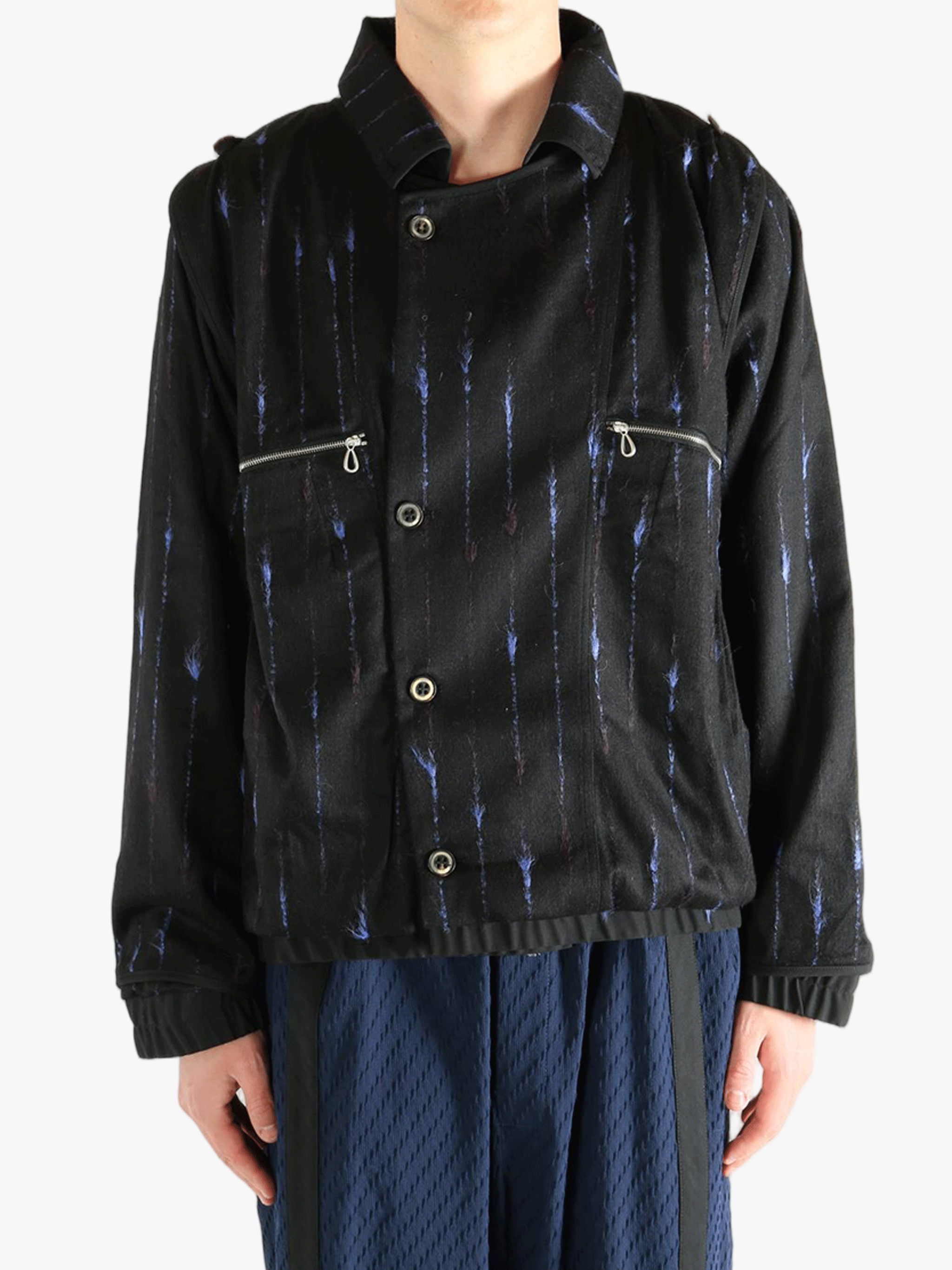 Black jacket worn by a person, showing the jacket's fit