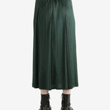 Green skirt worn by a person, showing the skirt's fit