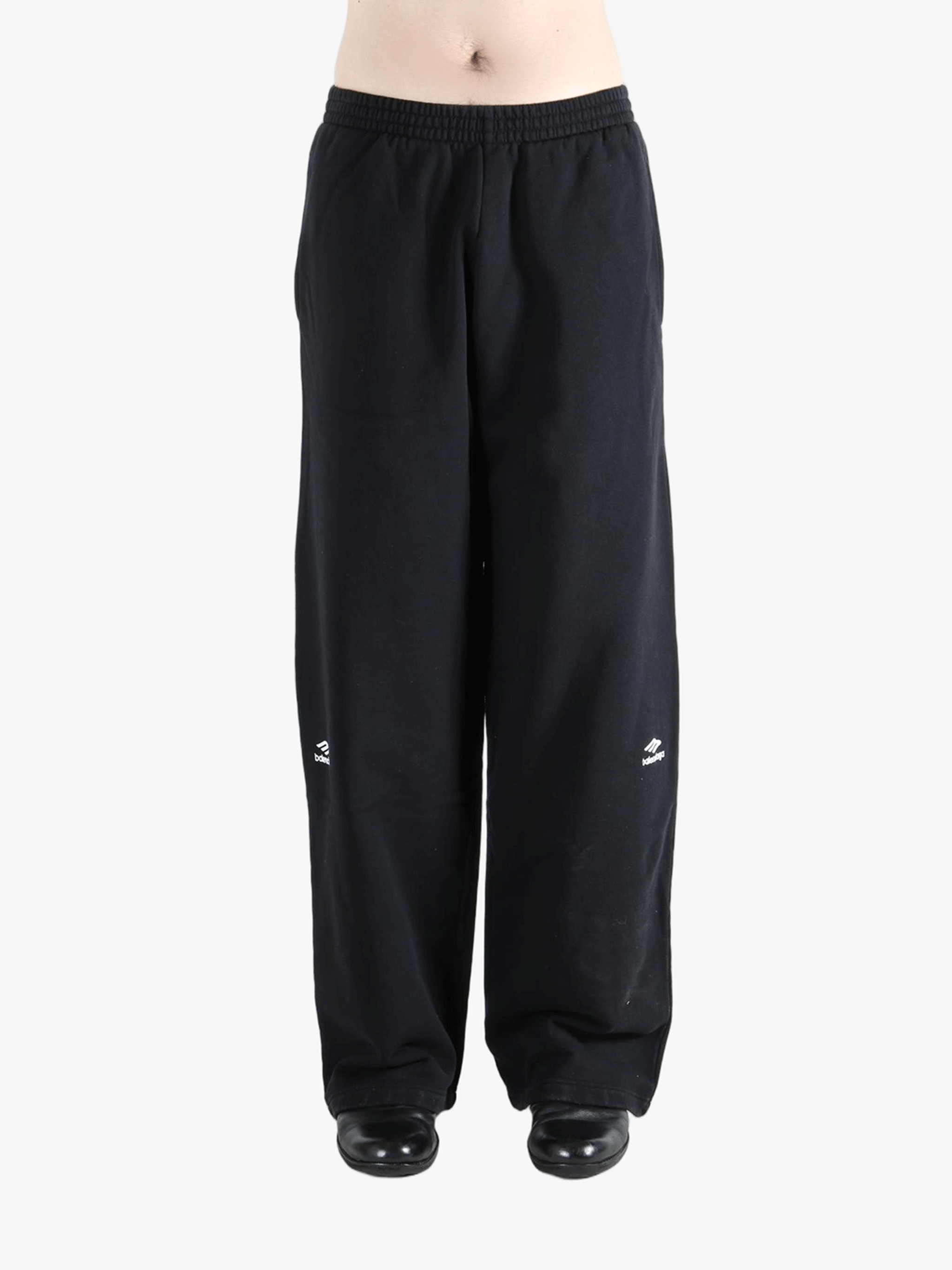 Black pants worn by a person, showing the pants fit