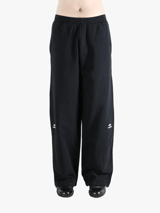 Black pants worn by a person, showing the pants fit