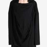 Black shirt worn by a person, showing the shirt fit
