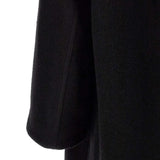 Close up of Black jacket, showing texture of the 100% virgin wool made fabric