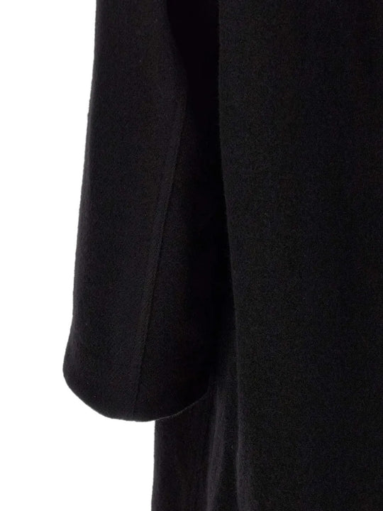 Close up of Black jacket, showing texture of the 100% virgin wool made fabric