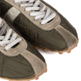 Close up of green shoes, showing texture of the polyester fabric