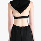 Black tops worn by a person, showing the tops fit