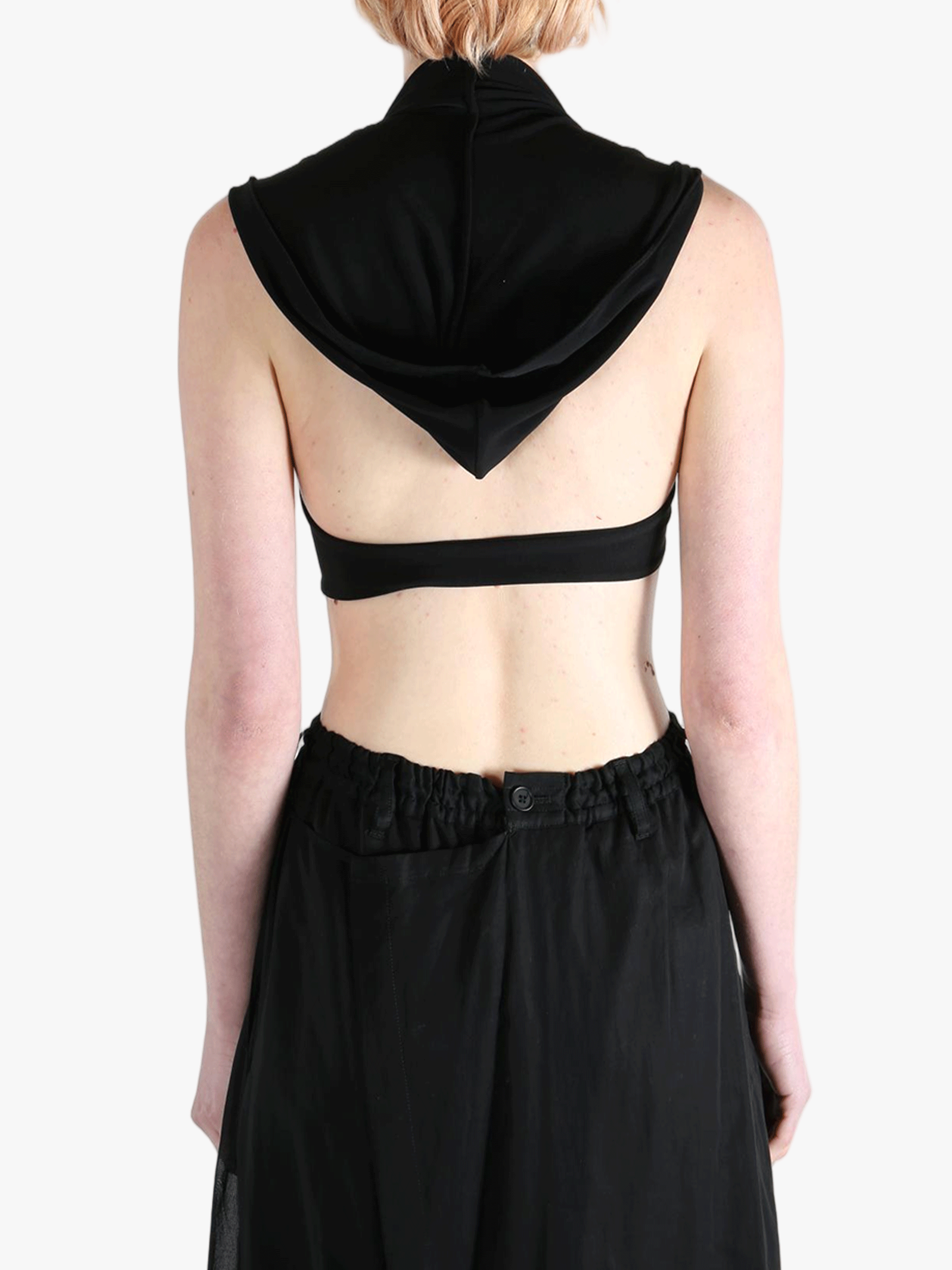 Black tops worn by a person, showing the tops fit