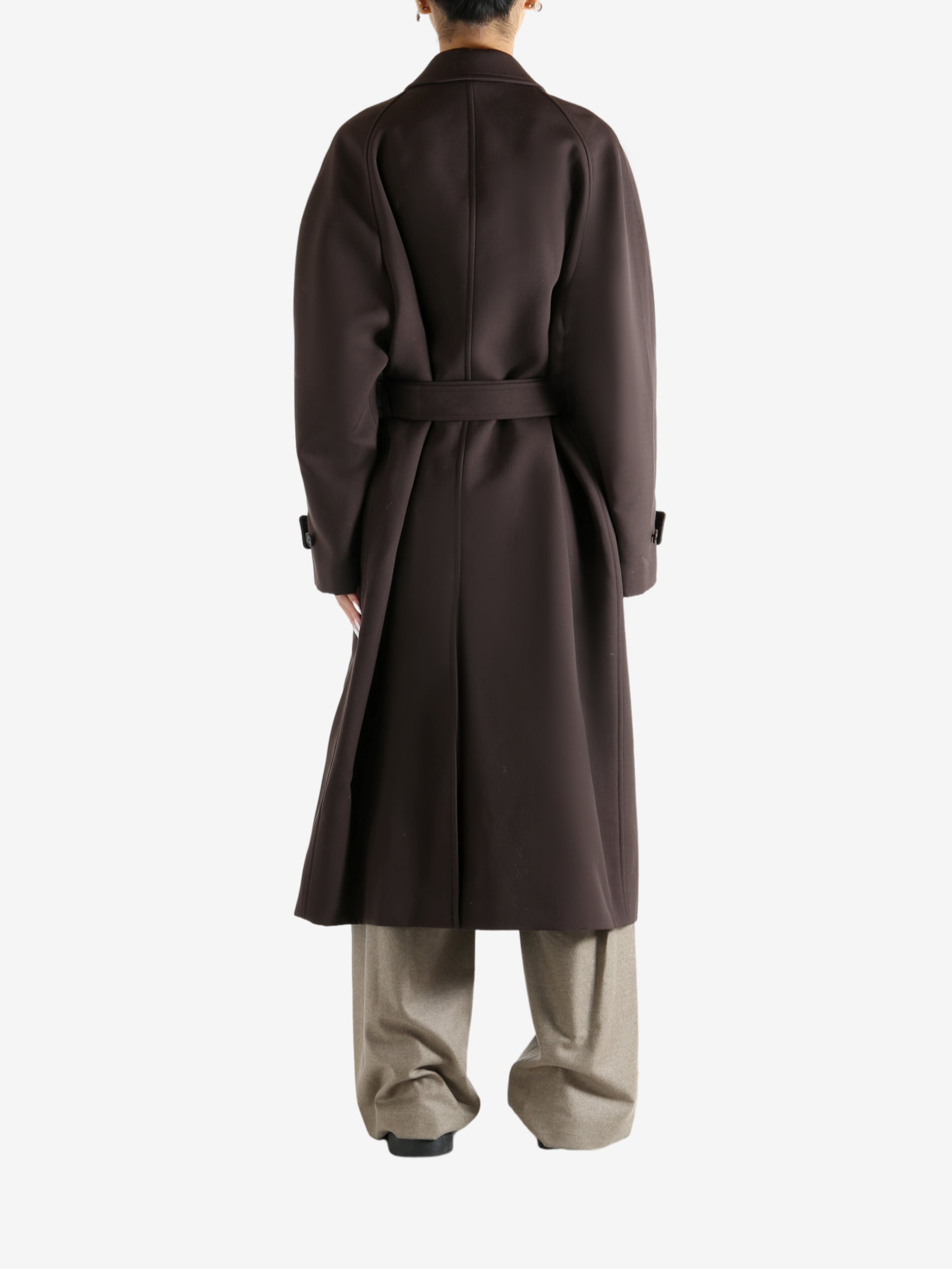 Brown coat worn by a person, showing the coat's fit