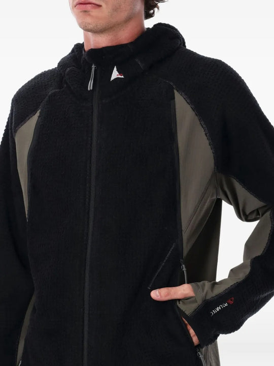 Close up of black jackets, showing texture of the polyester and elastane and nylon fabric