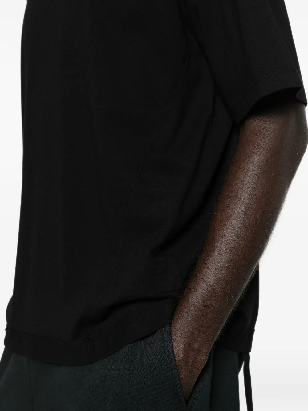 Black t-shirt worn by a person, showing the t-shirt fit