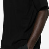 Black t-shirt worn by a person, showing the t-shirt fit