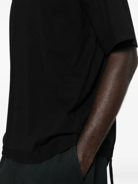 Black t-shirt worn by a person, showing the t-shirt fit