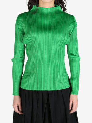 Green top worn by a person, front view