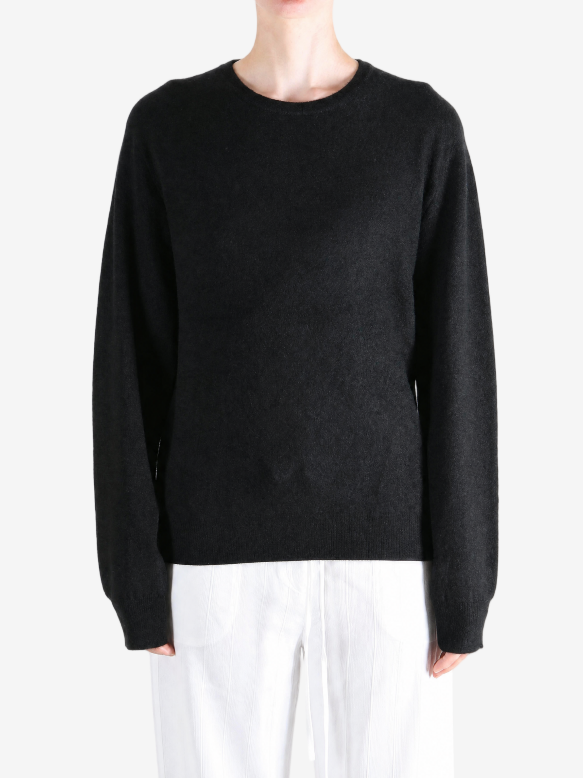 Black hoodie worn by a person, showing the hoodie fit