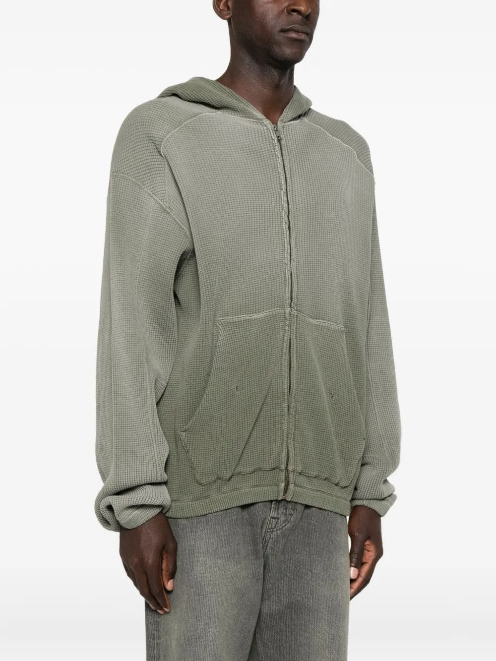 Green hoodie worn by a person, showing the hoodie's fit
