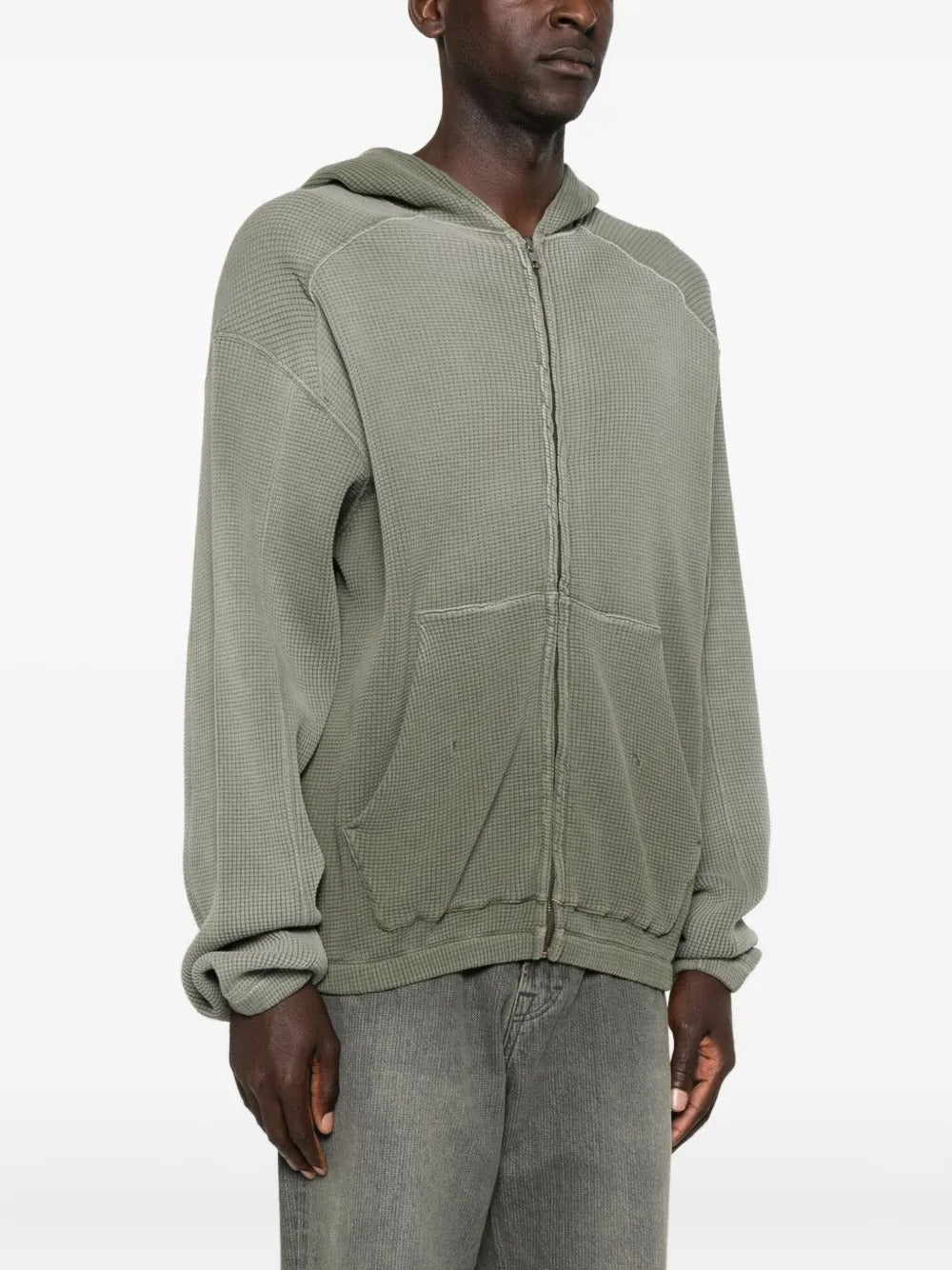 Green hoodie worn by a person, showing the hoodie's fit