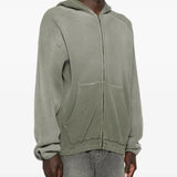 Green hoodie worn by a person, showing the hoodie's fit