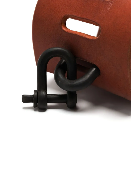 Close up of red bracelet, showing texture of the leather fabric