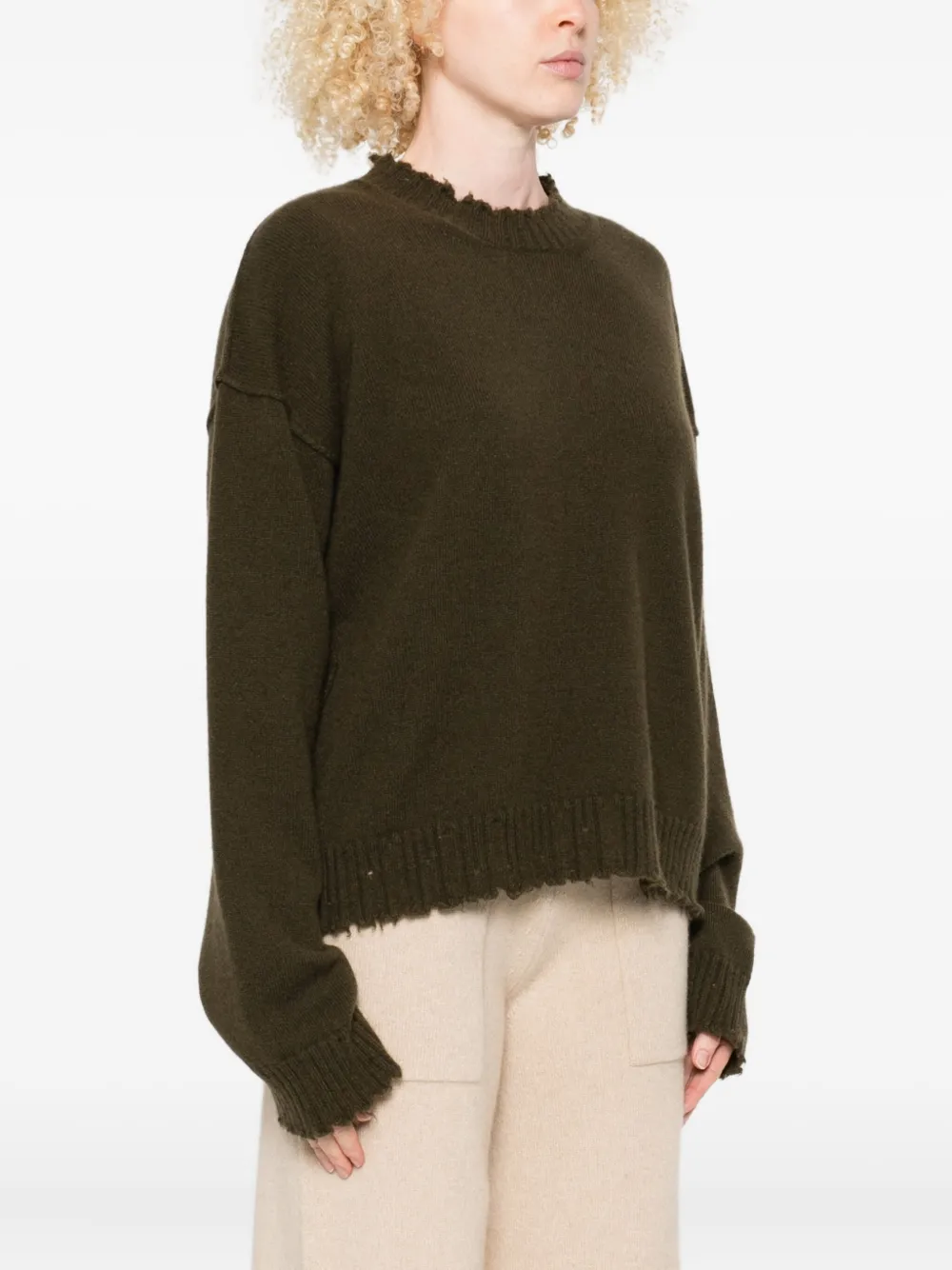 Green top worn by a person, showing the top fit