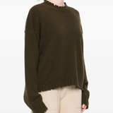 Green top worn by a person, showing the top fit