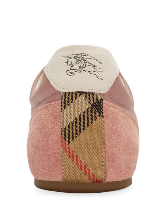 Close up of the pink sneakers, showing  texture of the lambskin