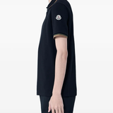 black shirts worn by a person, showing the shirts  fit