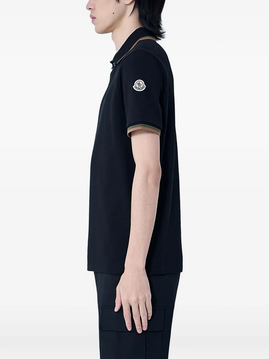 black shirts worn by a person, showing the shirts  fit