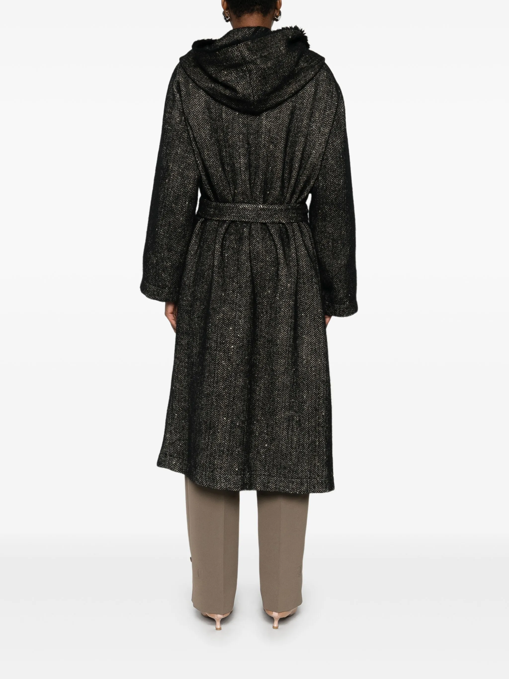 Black coat  worn by a person, showing the coat's fit