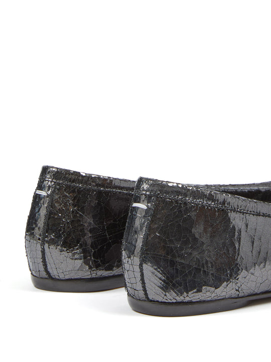 Close up of black flats, showing texture of the leather fabric